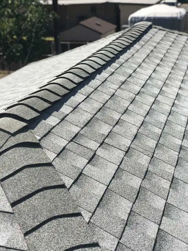 Close-up of ridge cap shingles along a roof peak